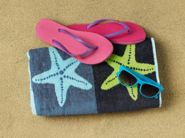 Slippers, sun glasses and towel — Stock Photo, Image