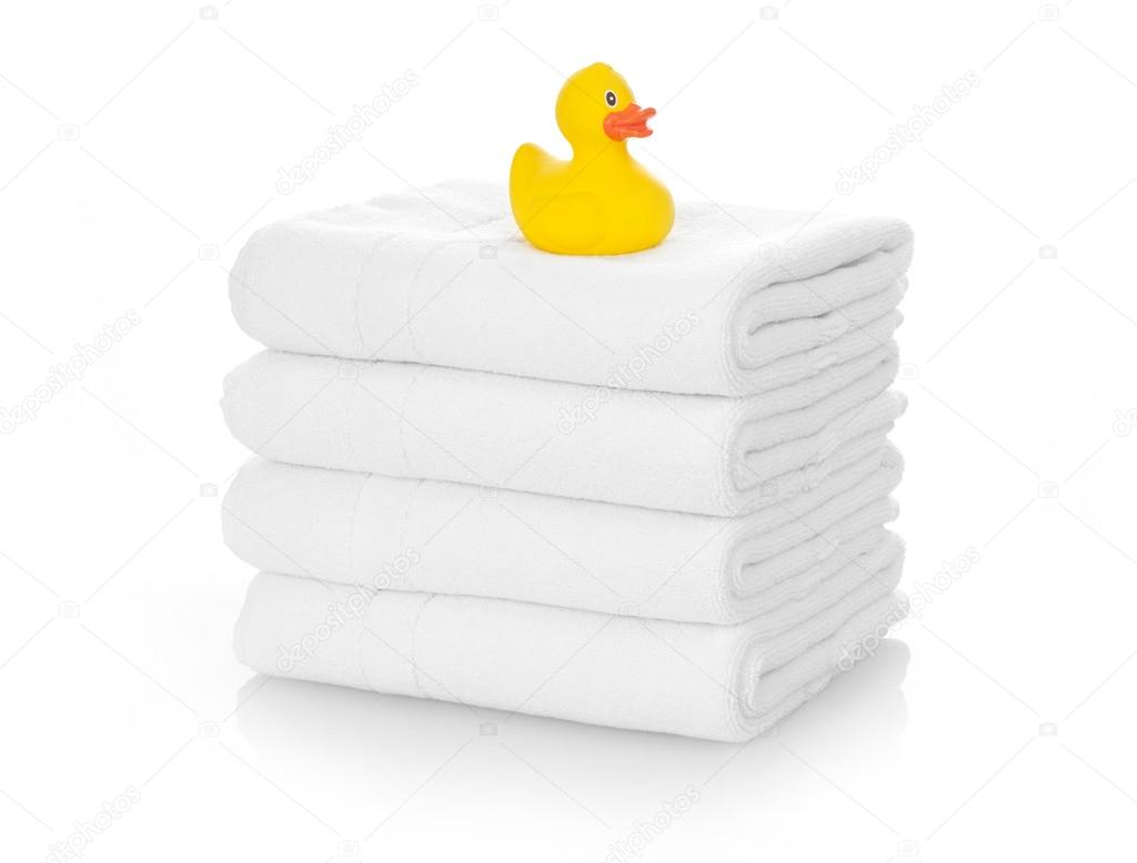 Rubber duck on white towels