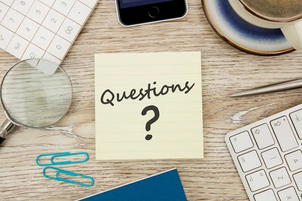 Questions message on desk — Stock Photo, Image