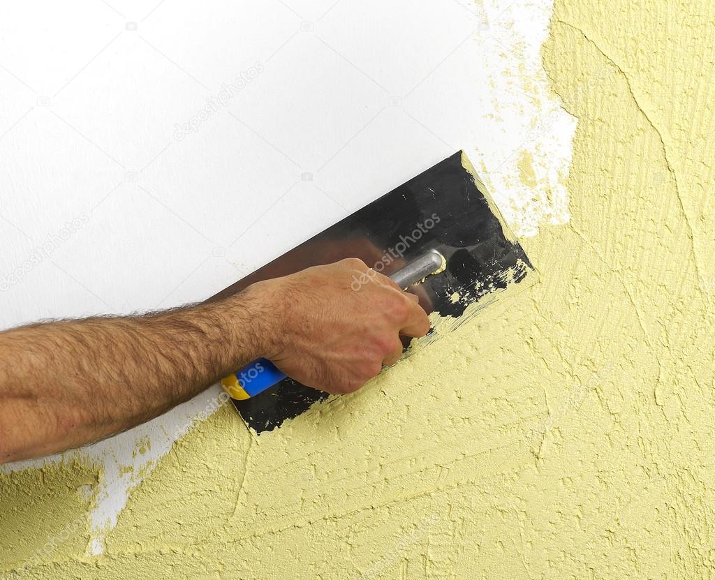 Construction worker plastering a wall