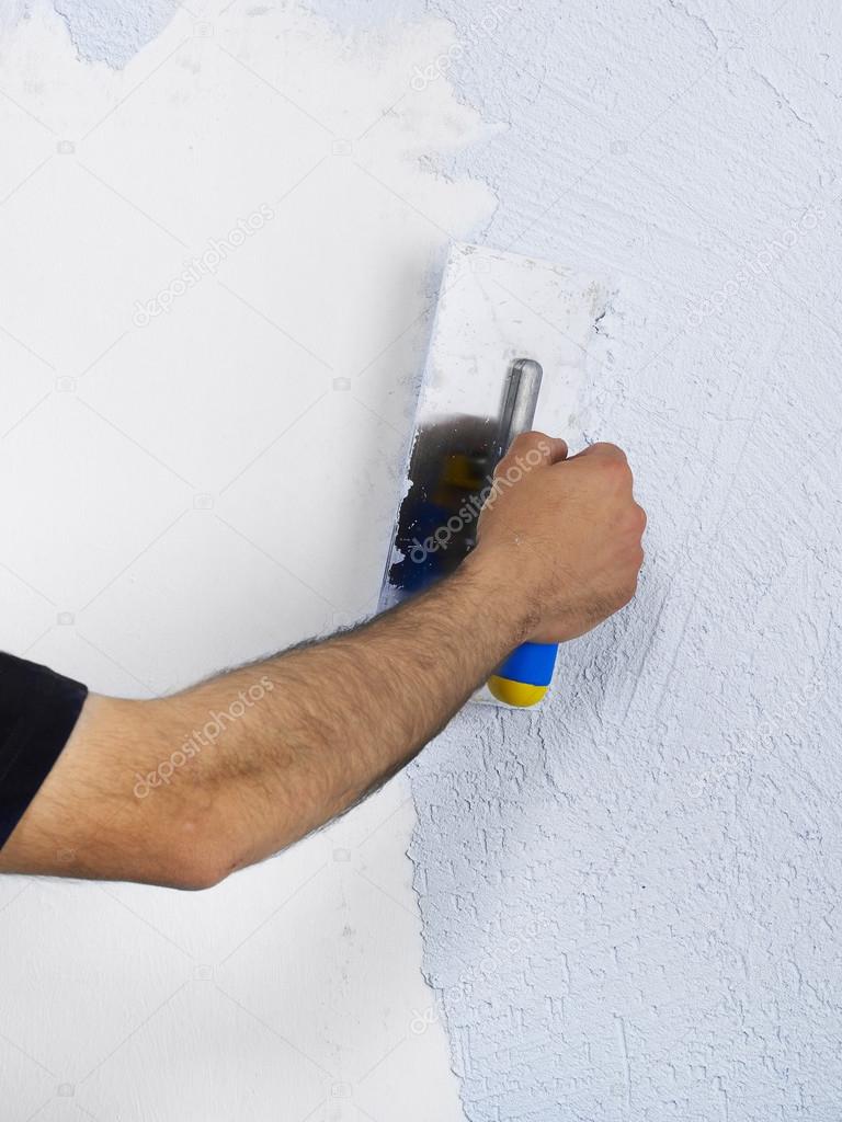 Applying plaster on a wall