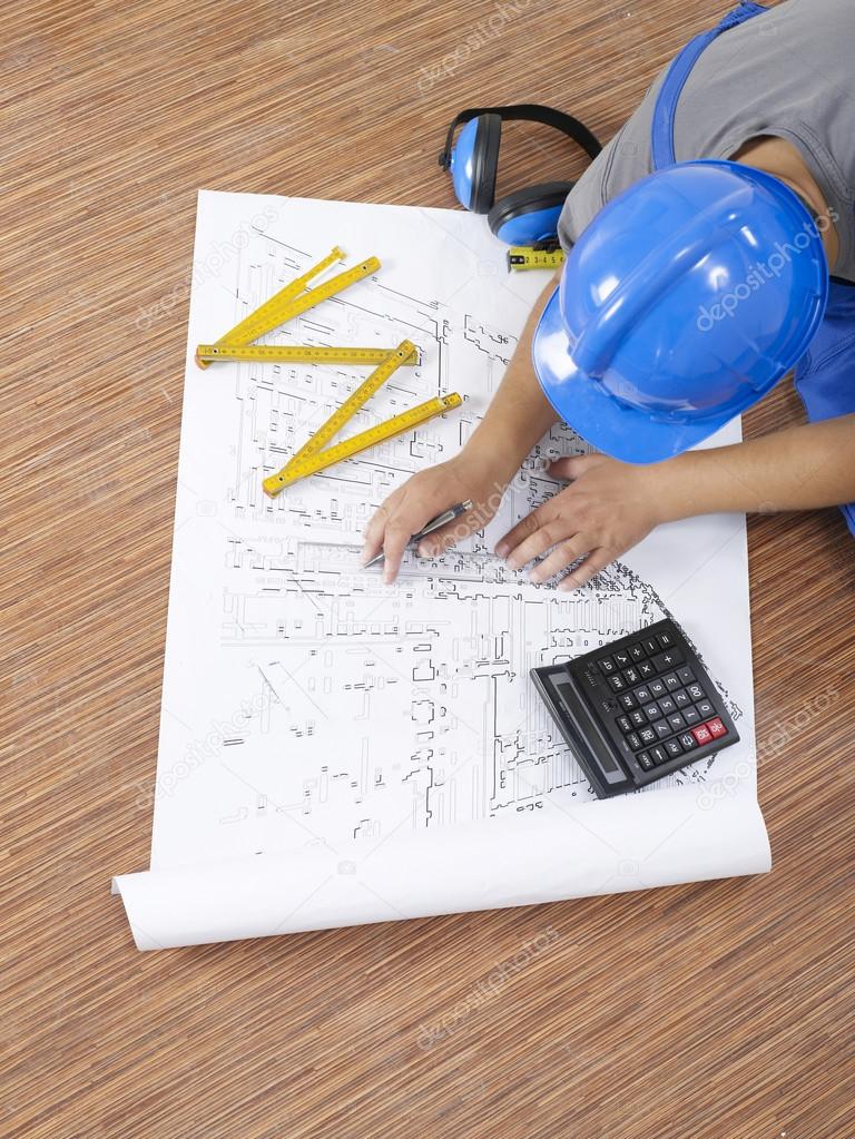 Building contractor with blueprints
