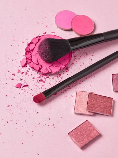 Face cosmetics on pink background
