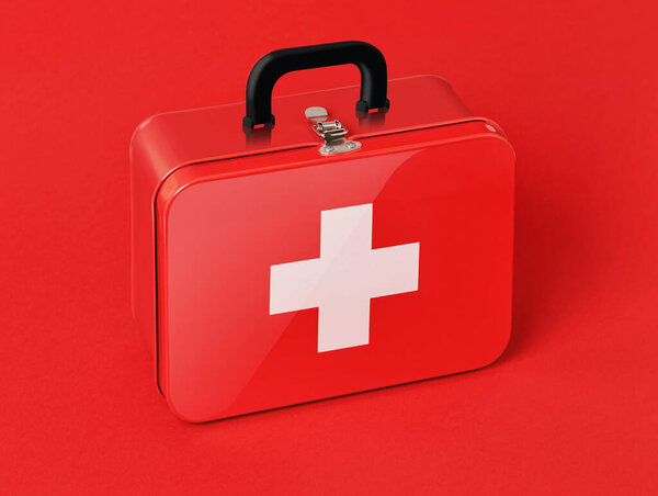 First aid kit on red background