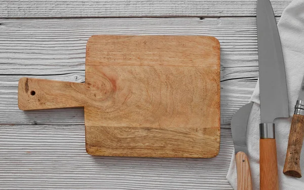 Wooden cutting board on wooden table