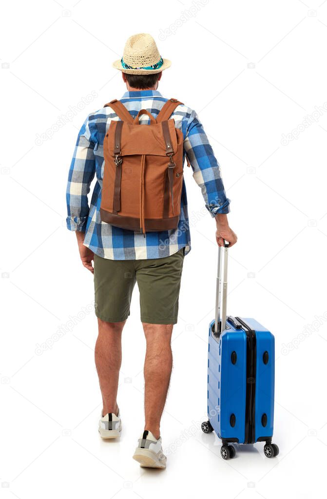 Man from behind with suitcase and backpack
