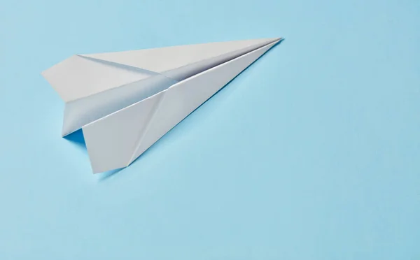 Paper airplane on blue background