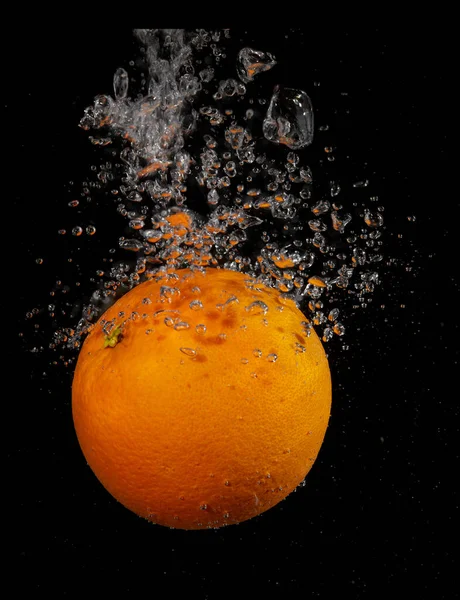 Orange splashing in water on a black background