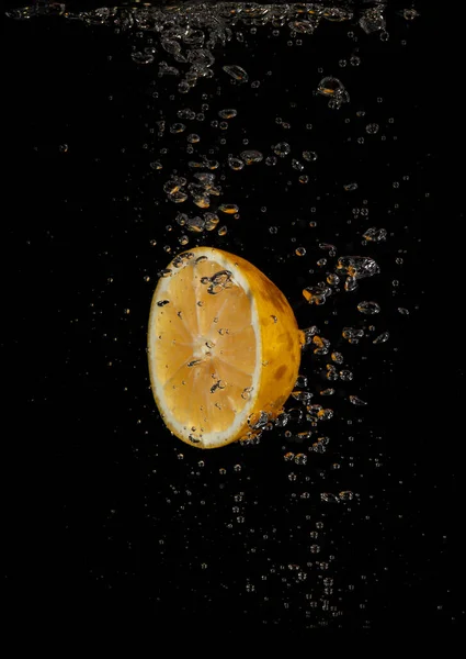 Zitrone Plätschert Wasser Auf Schwarzem Hintergrund — Stockfoto