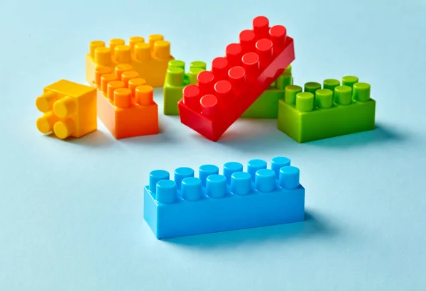 Plastic toy blocks on blue background