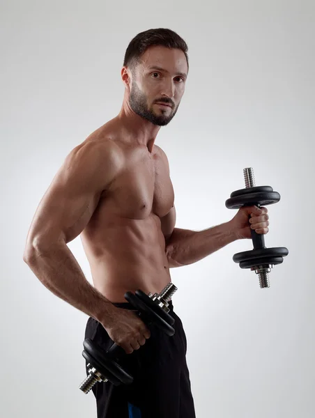 Sportsman lifting weights — Stock Photo, Image