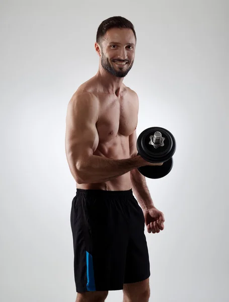 Cheerful man with dumbbell — Stock Photo, Image