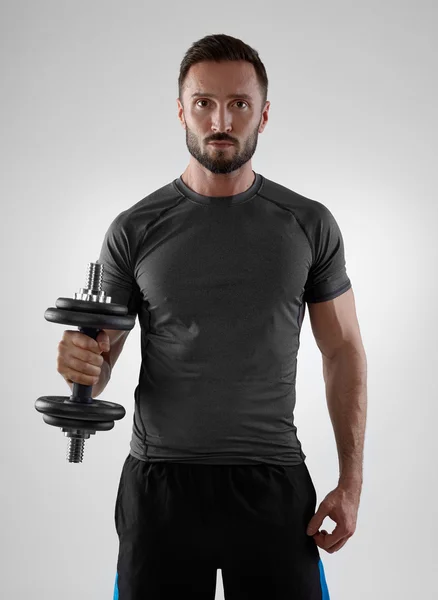 Sportsman weightlifting on grey — Stock Photo, Image