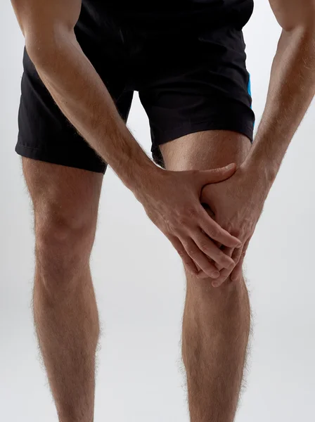 Knee pain, gray background — Stock Photo, Image