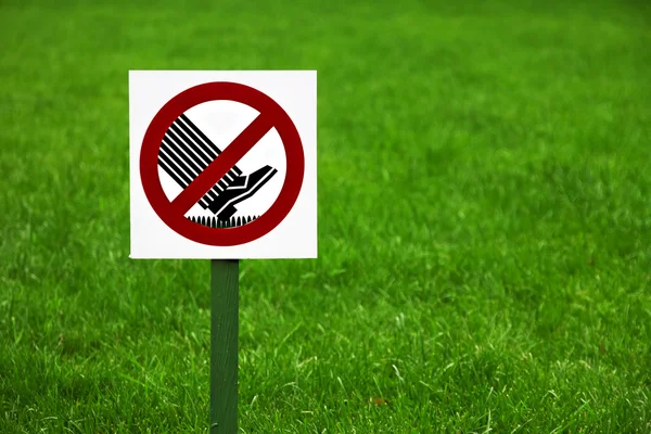 Forbidding sign on the lawn in the Park