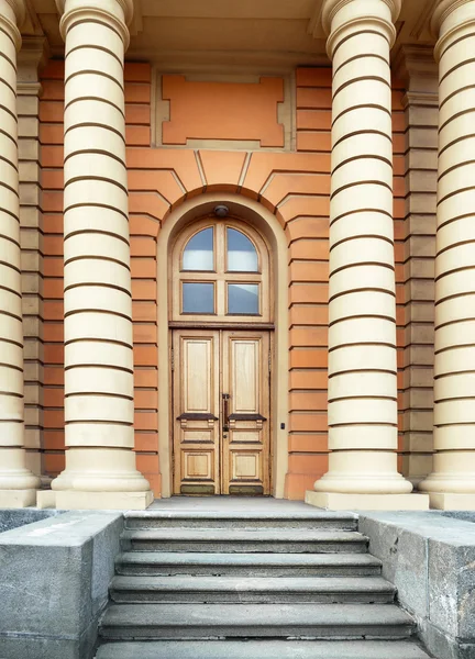 porch with a door and facade of the building