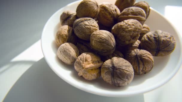 Walnut in a plate on the white background — Stock Video