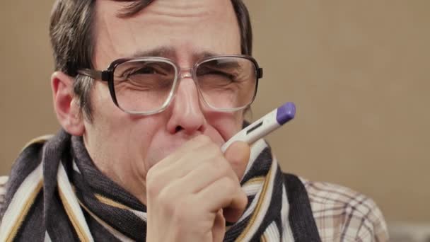 Coughing man in scarf with thermometer — Wideo stockowe