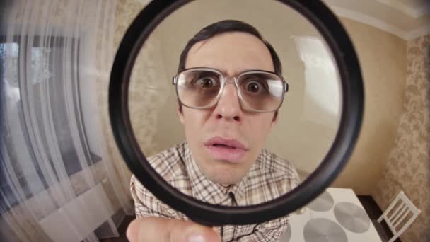 Funny man looks through magnifier glass — Stock Video