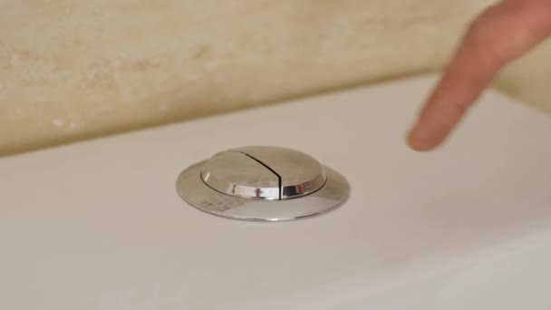 Finger pushing button and flushing toilet — Stock Video