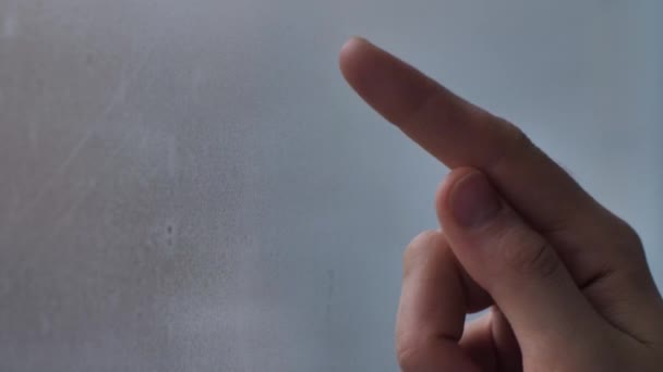 Girl drawing a heart on a misted window — Stock Video