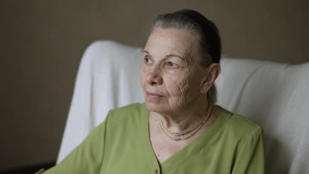 Portrait of grandmother sitting on armchair — Stock Video