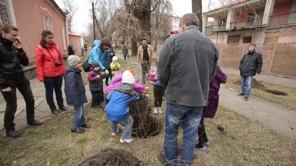 Children With Their Parents Panting Trees — Stock Video