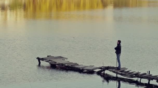 A man stands on the old bridge — Stock Video