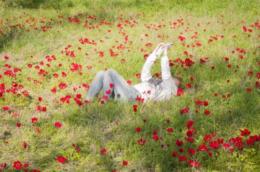 Girl making a selfie on a flower meadow clipart