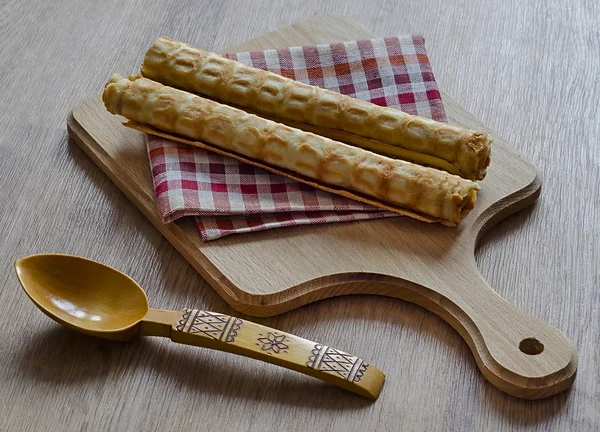 Wafer rolls on a wooden board — Stock Photo, Image