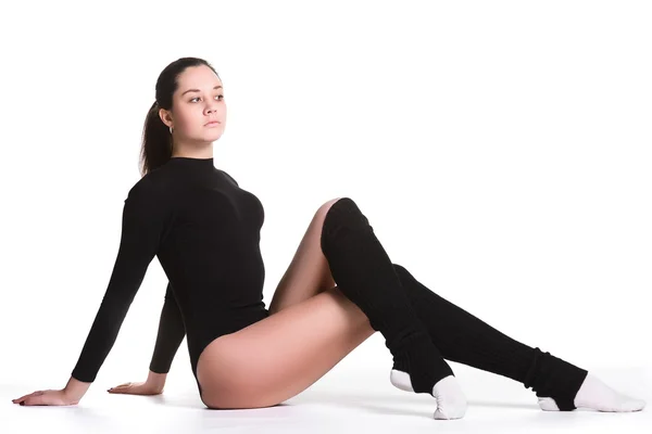 Young cute woman in gymnast suit resting on white background — Stock Photo, Image
