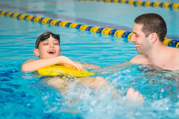 Instructor teaches the boy swimming in a pool — Stock Photo, Image