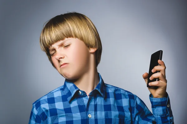 Closeup portret van bezorgd gestresst jongen met mobiele gaan irritatie op grijze achtergrond — Stockfoto