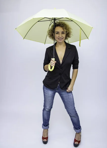 Beautiful girl umbrella in the rain joy happiness funny woman laughs.