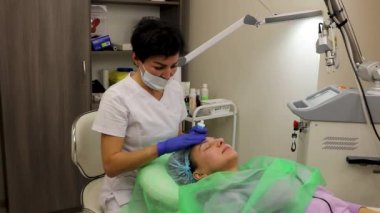 cosmetology, laser resurfacing, facial cleansing in the beauticians office, in a beauty salon.