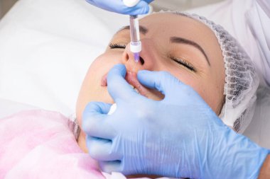 Kozmetik, dudak büyütme, güzellik salonunda güzellik aşıları, yakın çekim.