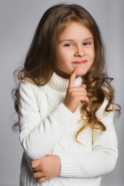 Ritratto di bambina che pensa, su sfondo grigio — Foto Stock
