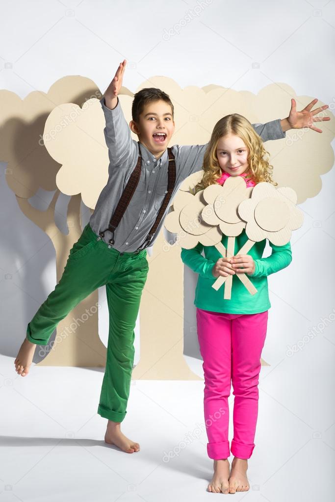 Love concept. Couple of kids. boy gives a girl cardboard flowers