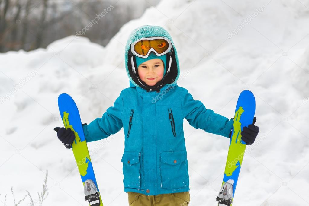 The boy in a blue jacket on skiing outdoor winter day