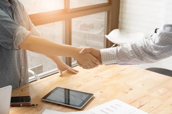 Businessman and partner shaking hands in office — Stock Photo, Image