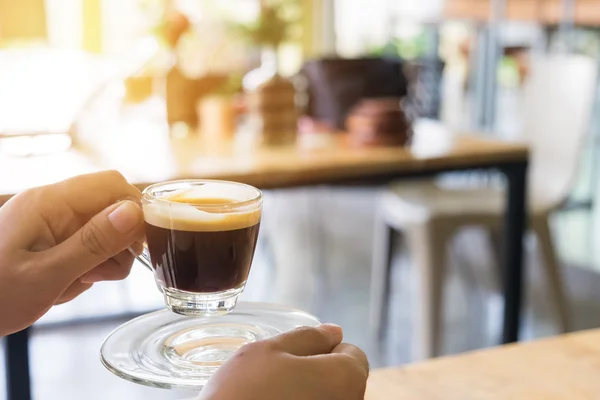 Mulher mão segurando quente café expresso tiro . — Fotografia de Stock