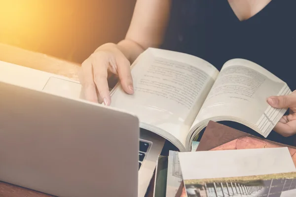 Gros plan de la main d'un étudiant lisant un livre à la bibliothèque ton vintage . — Photo