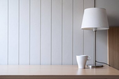 Alanı olan işyeri - Lamba eski ahşap masa üzerinde beyaz tonda sert beton duvar boşluğu ile