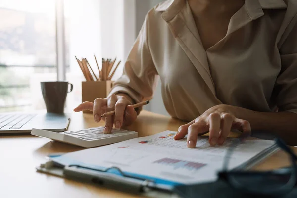 Close up Business woman or accountant using calculator with computer laptop, Business accounting, budget and loan paper at home — Stock Photo, Image