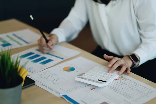 Business women using calculator with computer laptop, Business accounting, budget and loan paper in office. — Stockfoto