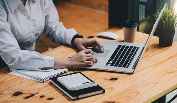 Business woman using calculator with laptop computer, Business accounting, budget and loan from marketing report — Stock Photo, Image