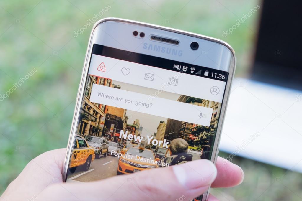 CHIANG MAI, THAILAND - NOV 21, 2015: A man hand holding screen shot of  Airbnb on samsung galaxy s6 edge. an online platform for accommodation, search and short-term private rental accommodation worldwide.