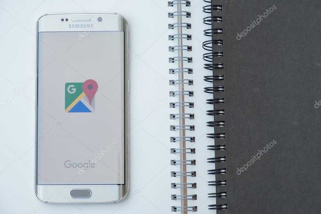 CHIANGMAI, THAILAND -NOV 28, 2015, A man hand holding screen shot of google maps on samsung galaxy s6 edge. Google Maps is a web mapping service application and technology provided by Google.