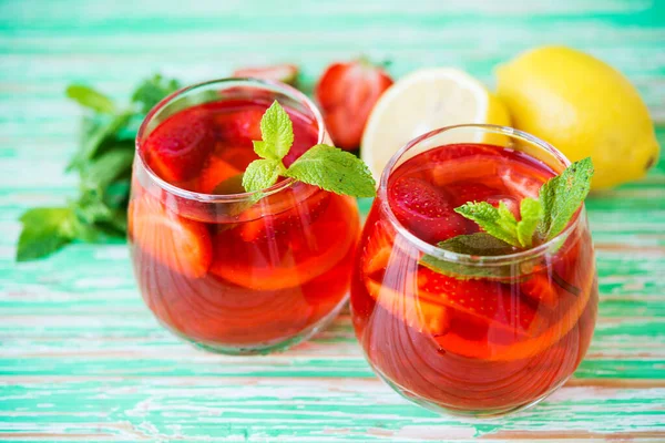 Homemade strawberry lemonade on a rustic background, a refreshing summer drink, selective focus