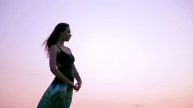 Young Woman Posing. Evening Sky. Slow motion